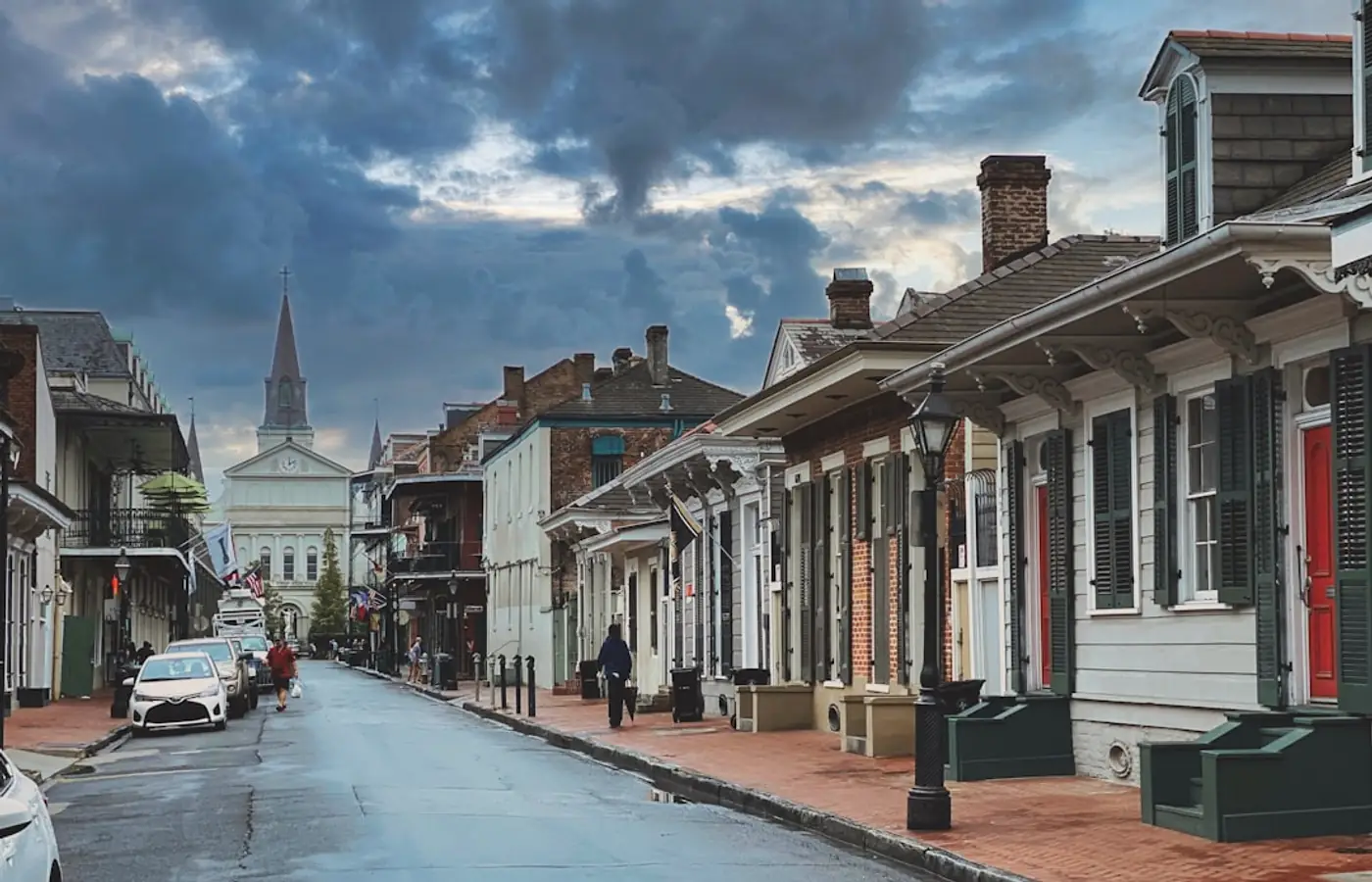 A street of row houses under a cloudy sky.